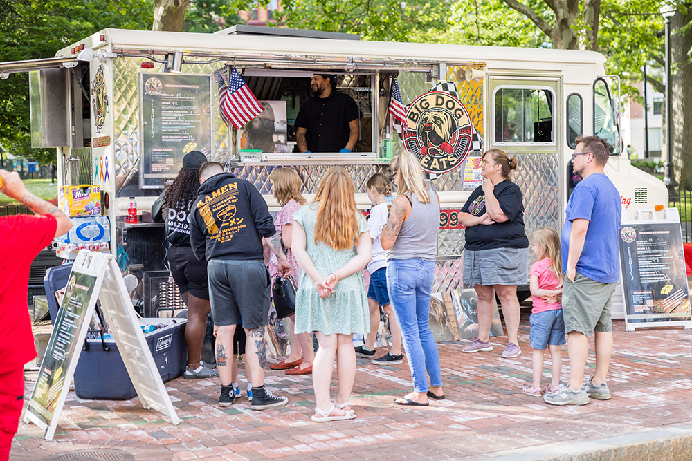 Photo of people lined up outside of a food truck in Providence.