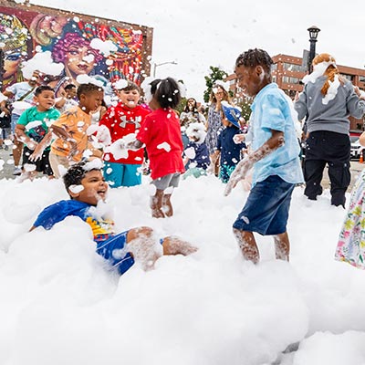 Photo of kids playing in bubbles